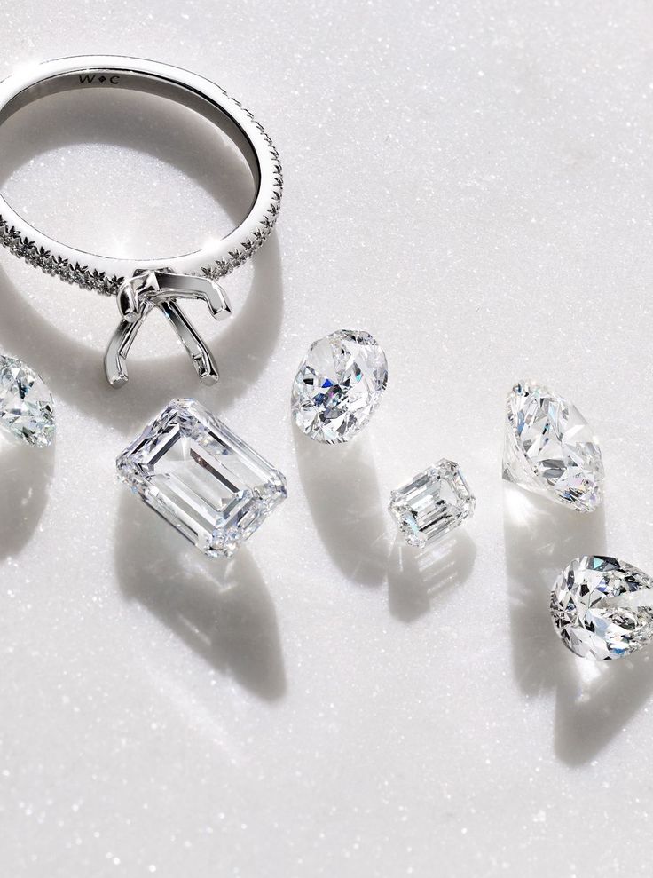 Diamond engagement ring setting surrounded by loose lab-grown diamonds